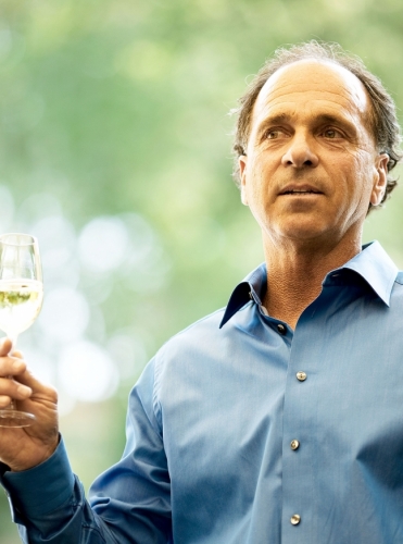 David Abreu Kenzo Estate viticulturist holding a glass of wine